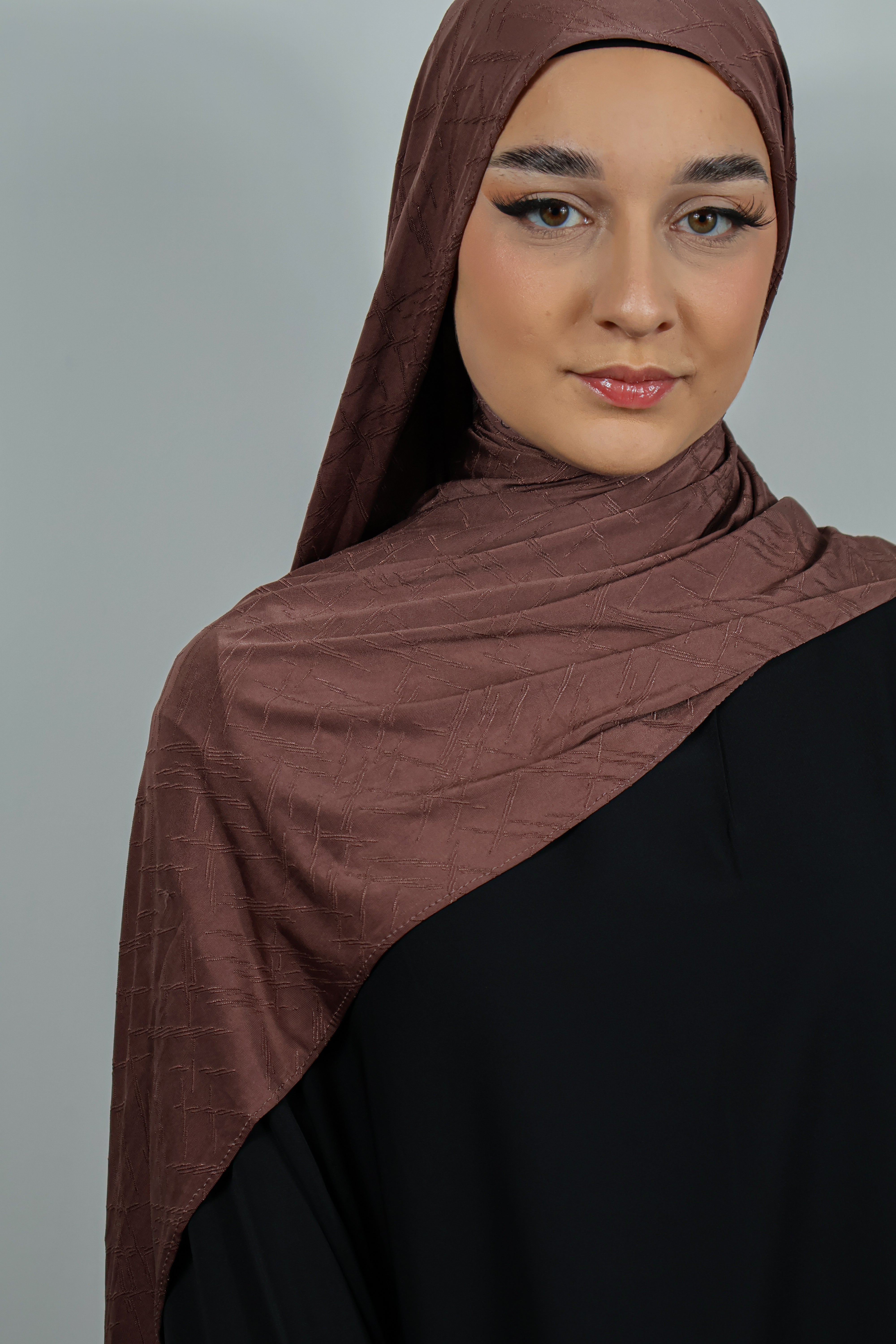 Jersey Prestige rose poudré, drapé avec des plis délicats pour un effet raffiné.